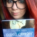 Photo of Ashlee reading a copy of "Ollie's Odyssey"